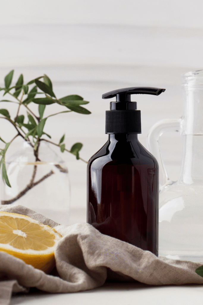 amber pump bottle with linen towel in front