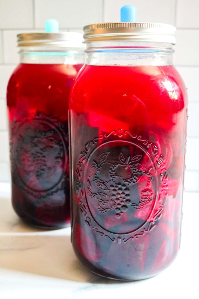 two glass jars of beet kvass