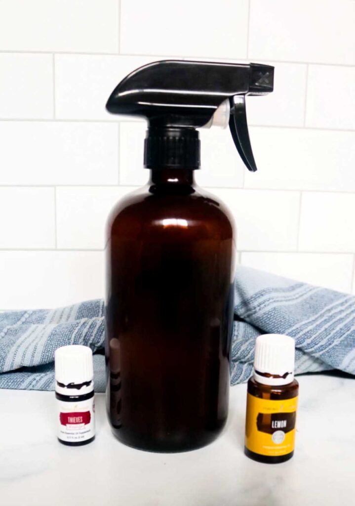 amber spray bottle with essential oil bottles on either side