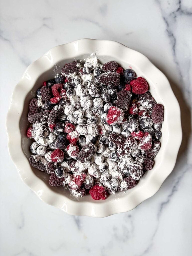 mixed berries in pie dish with corn starch on top