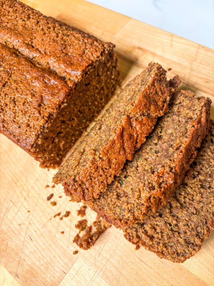 fresh milled sourdough zucchini bread sliced on wood cutting board